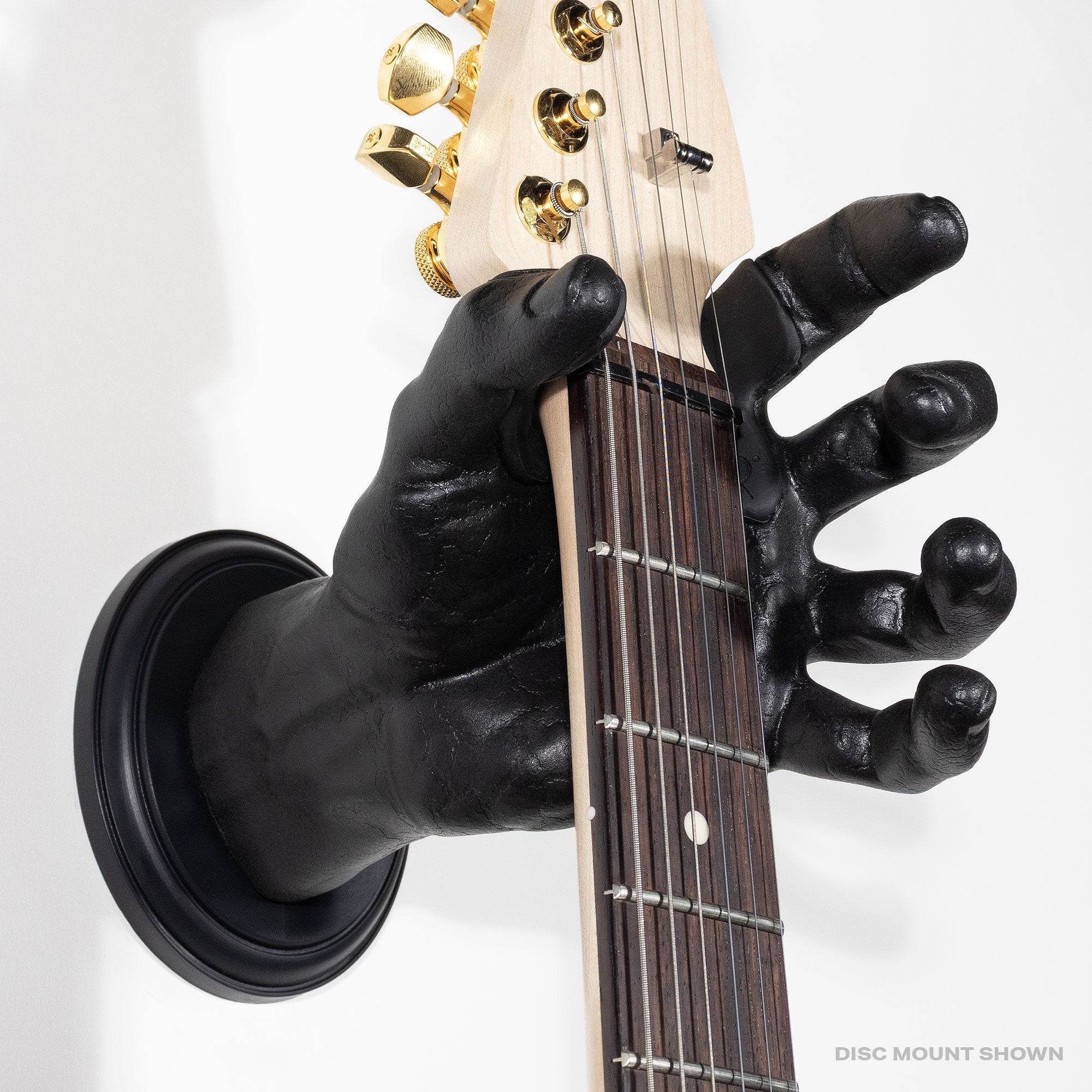 Black hand wall mount holding a guitar on a white background.