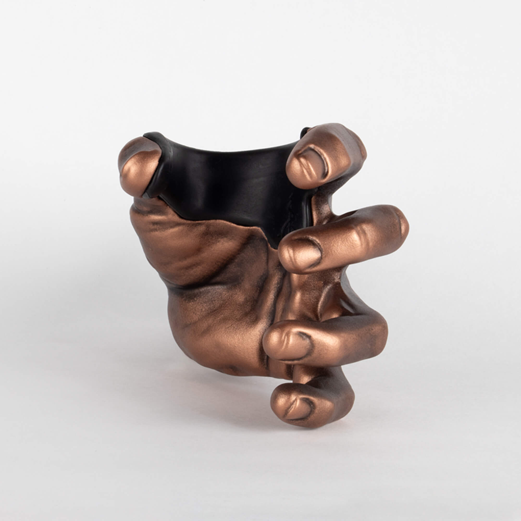 Guitar wall hanger in the shape of a copper colored hand.