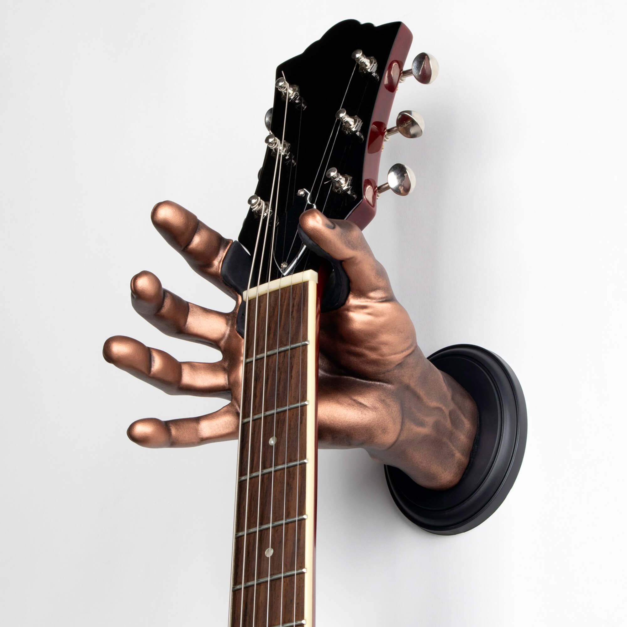 Copper hand wall mount for a guitar.