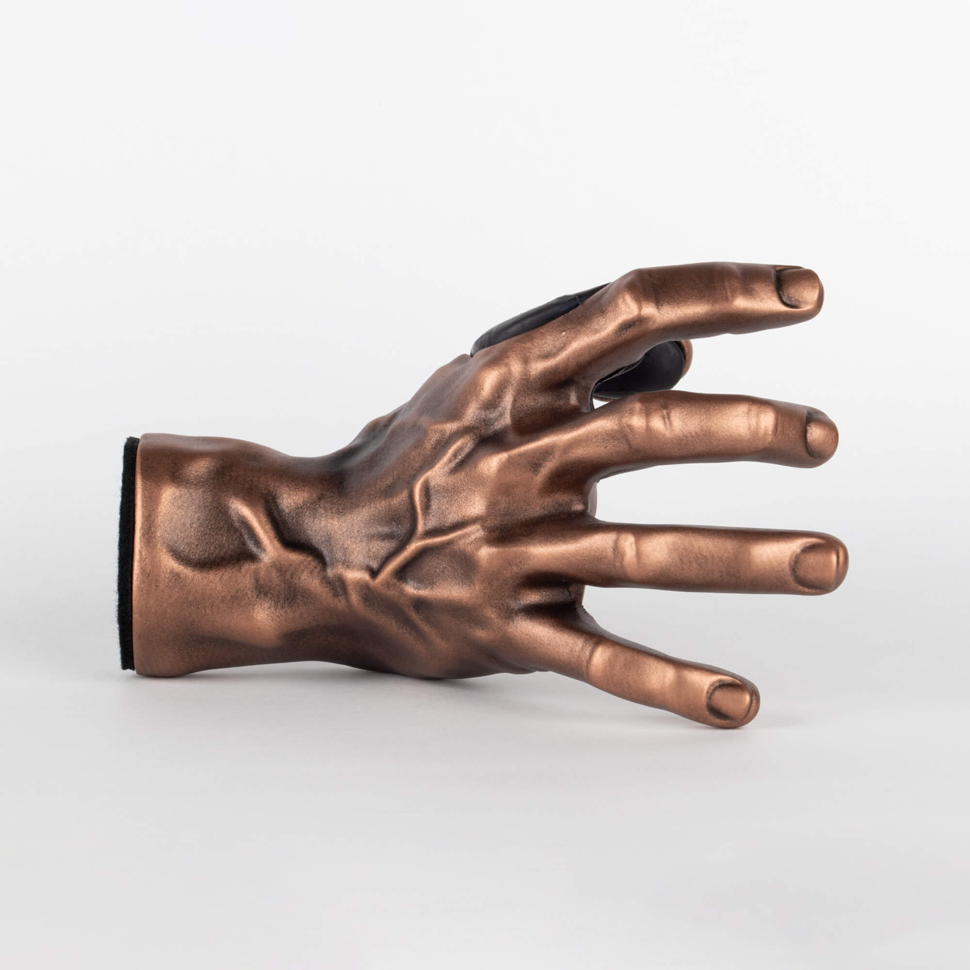 Outside view of copper antique hand bass wall mount for music room or studio.