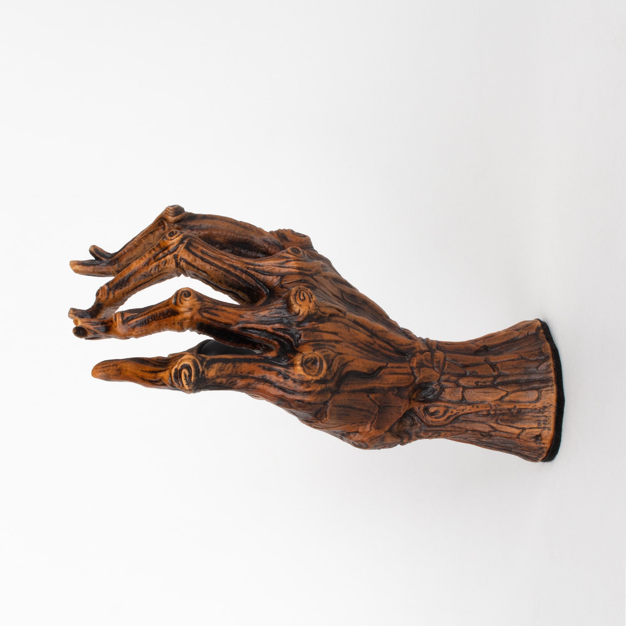 Guitar bracket hook for wall shaped like a tree branch hand.