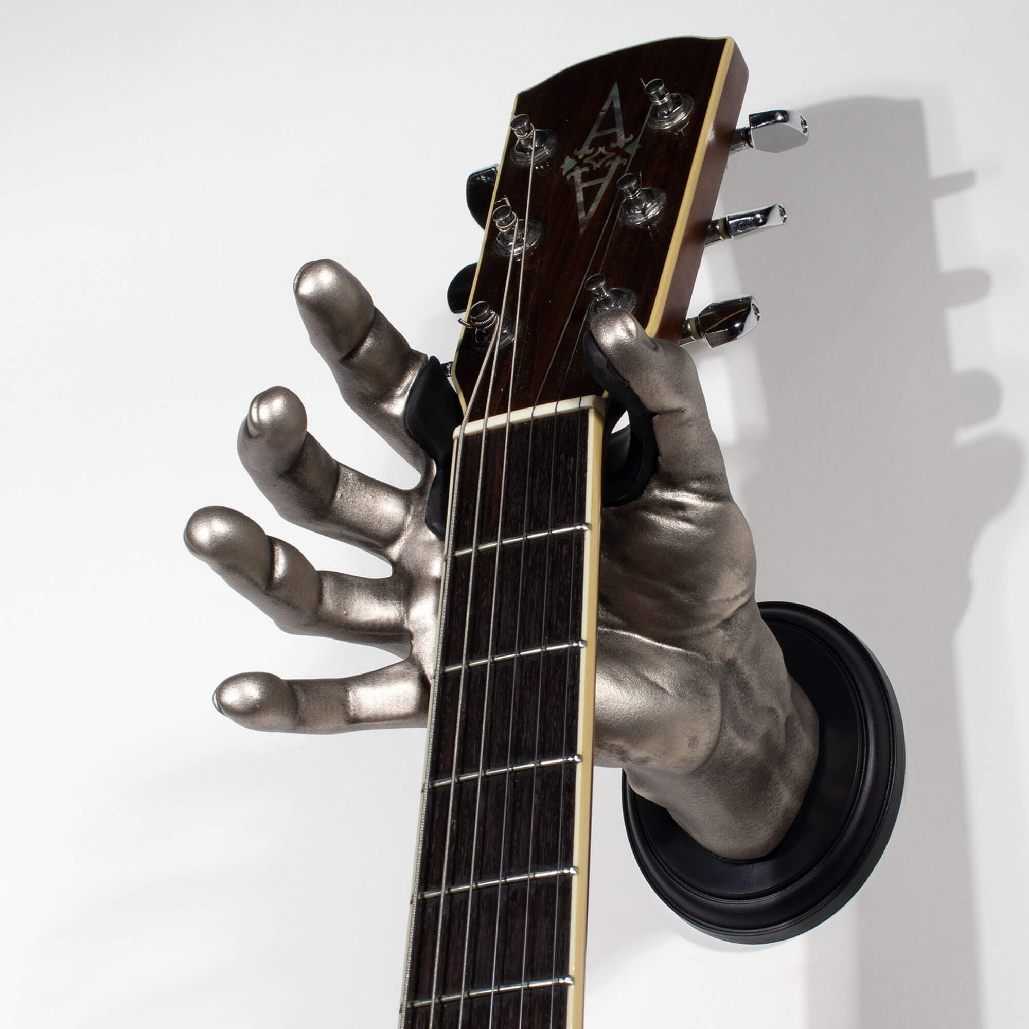 Silver hand shaped guitar hanger wall mounts from GuitarGrip.