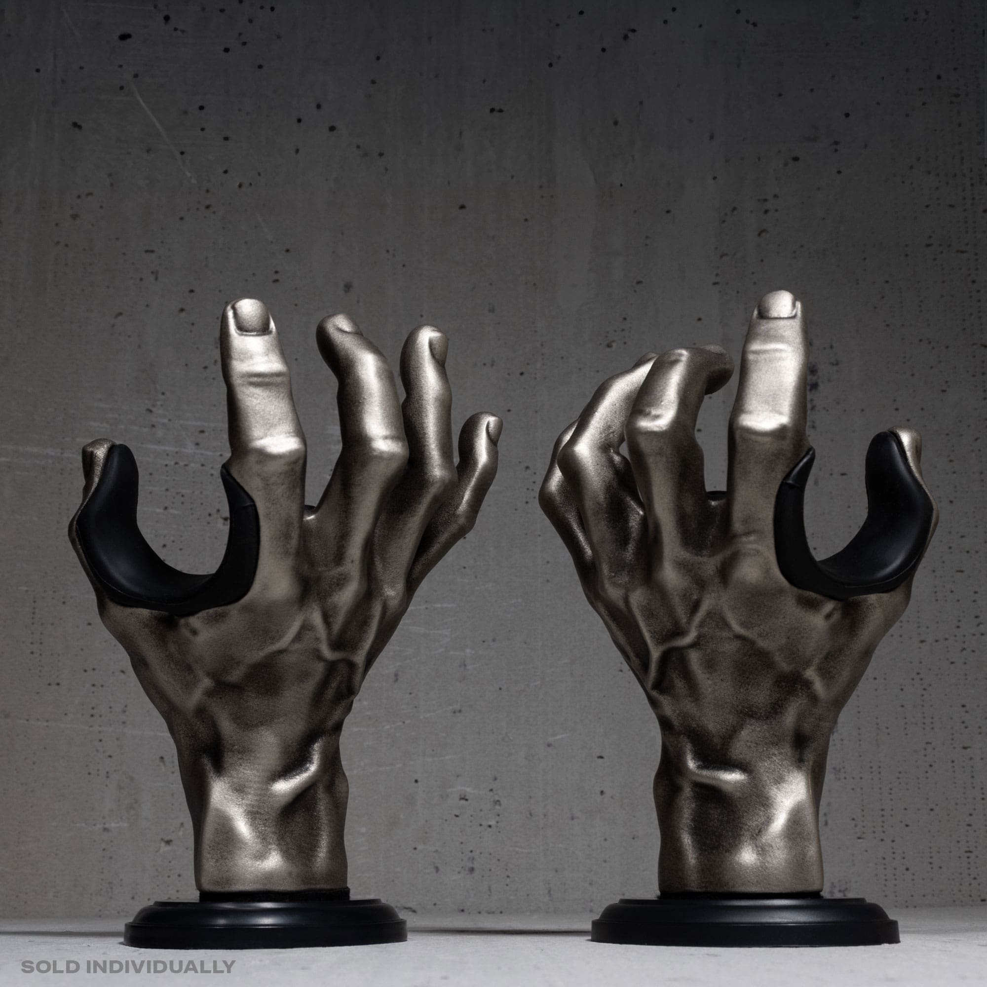 Silver metallic hand guitar hangers matching left and right models.