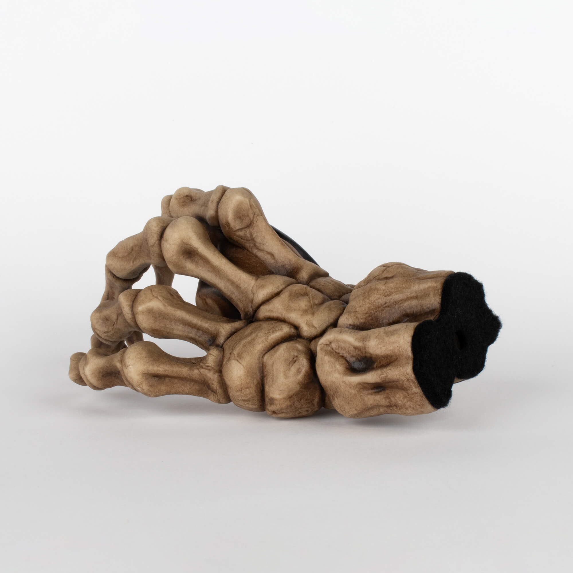 Back view of bass guitar instrument wall mount to display instruments in the shape of a skeleton right hand.