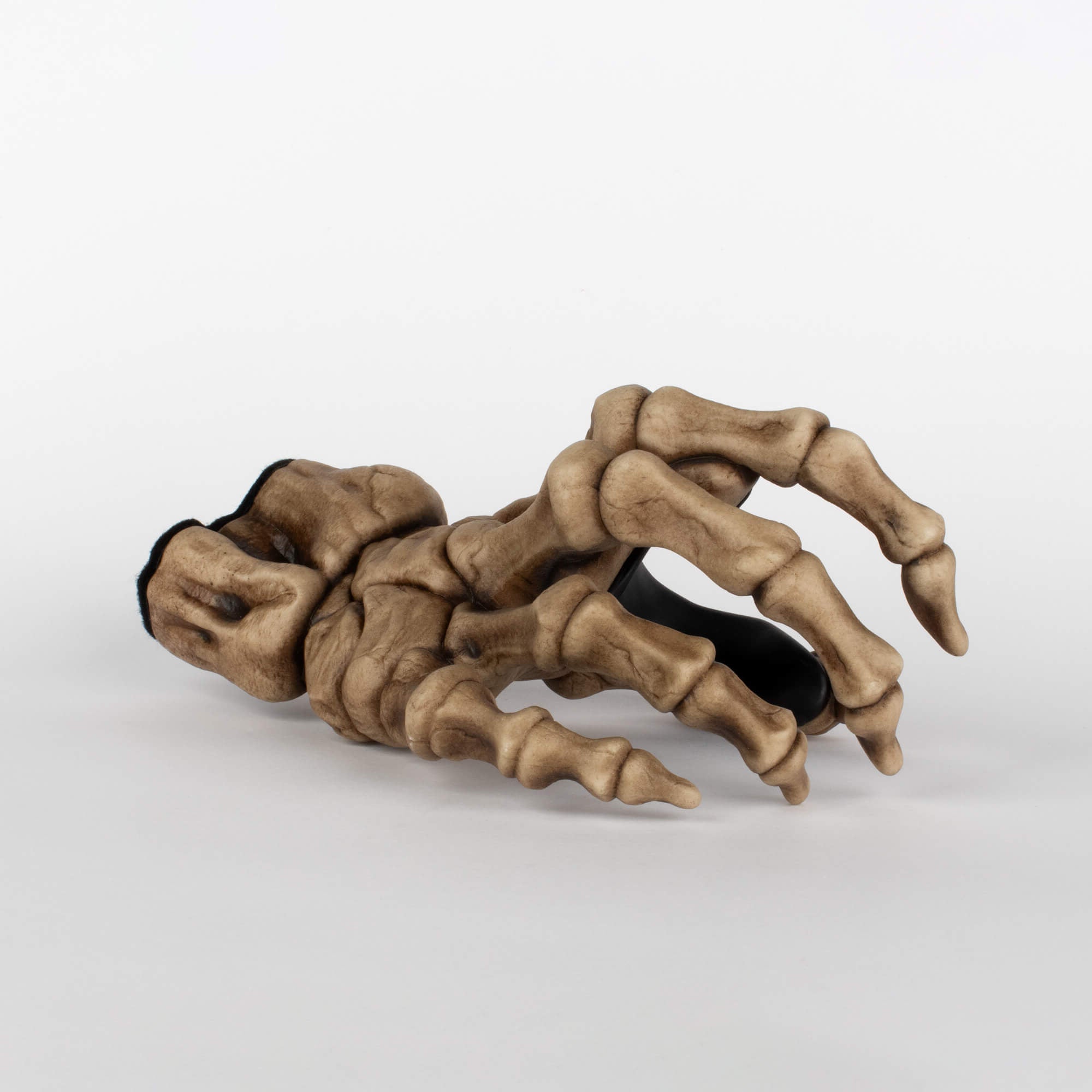 GuitarGrip beige bone skeleton wall hanger for hanging electric and acoustic guitars, angled front view on white background.