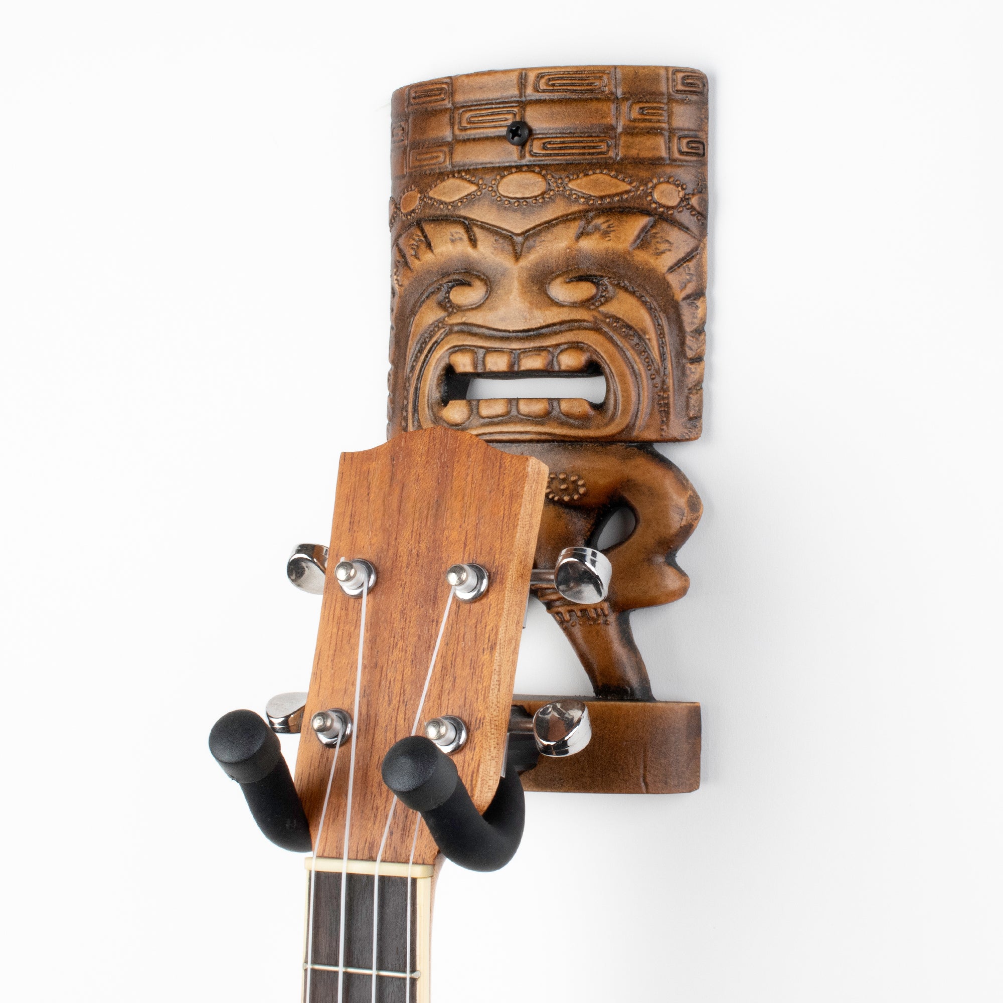 Tiki brown hanger holding ukulele hanger.