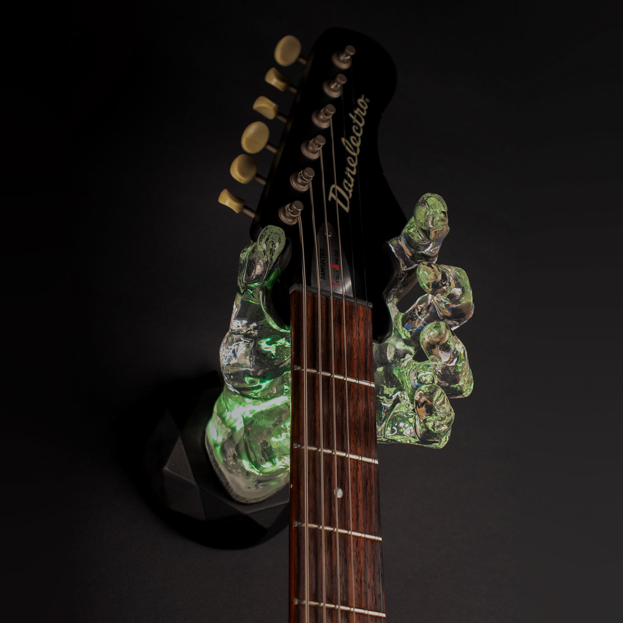 GuitarGrip Wall Hanger Mount for guitars, bass and other stringed instruments. On black background.