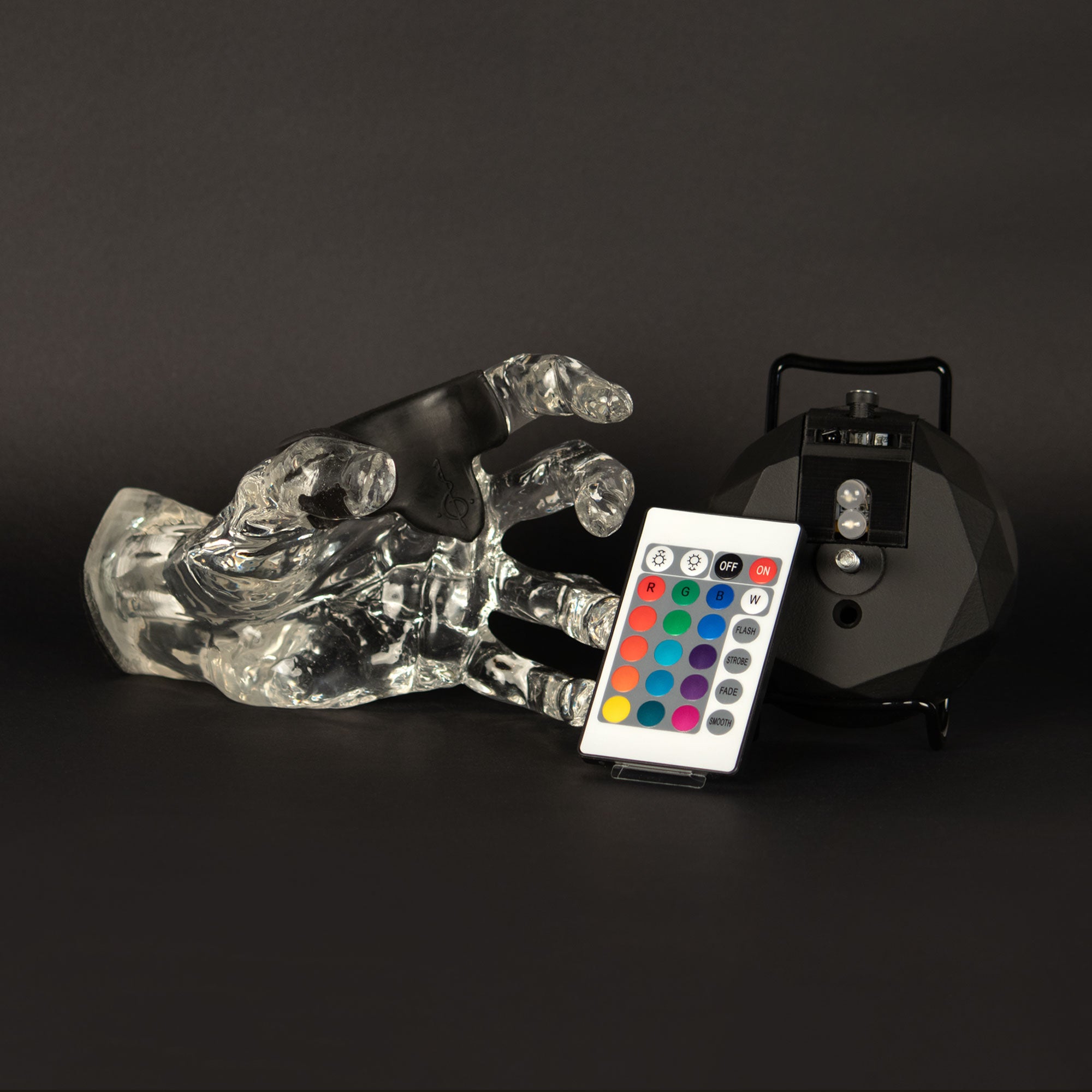 GuitarGrip hand instrument mount for wall hanging display. Included remote, rechargeable battery and mounting hardware.