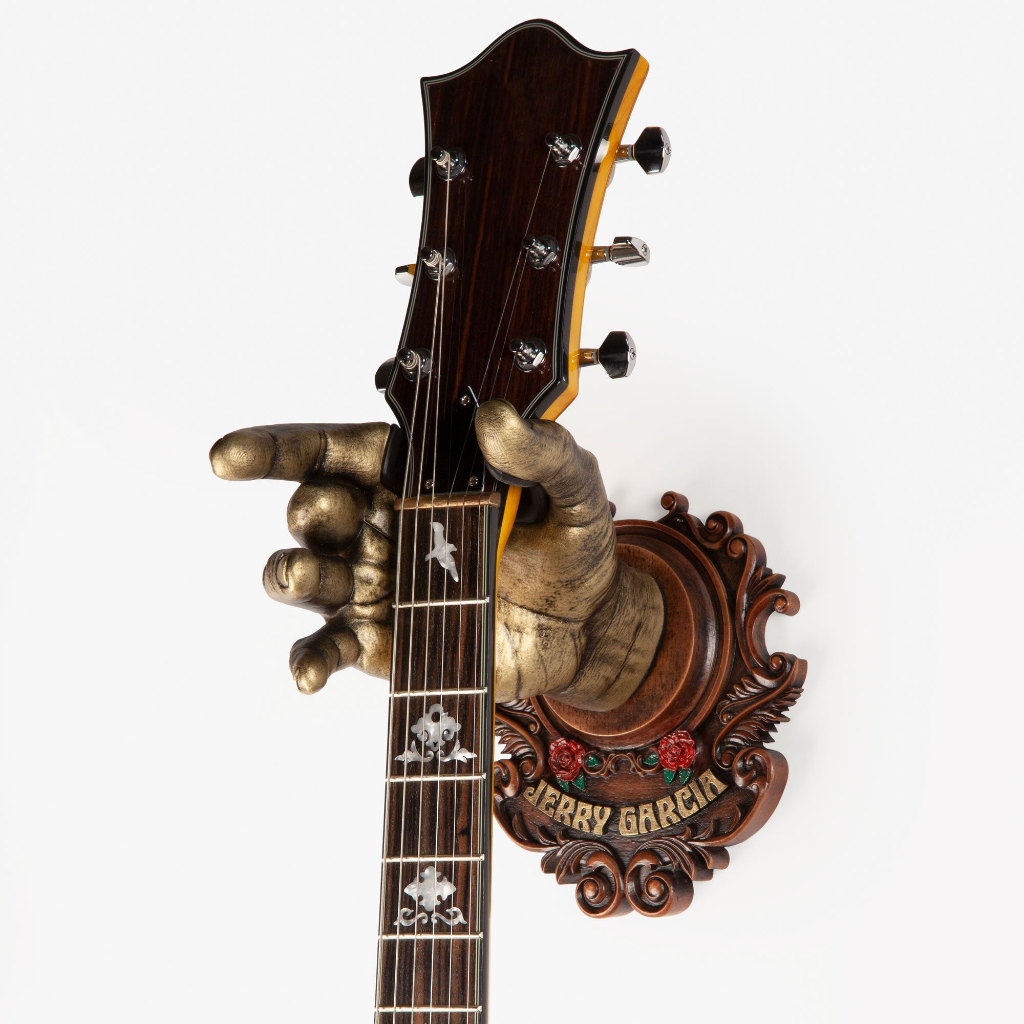 Guitar hanger fashioned after Grateful Dead guitar player with wood back plate.