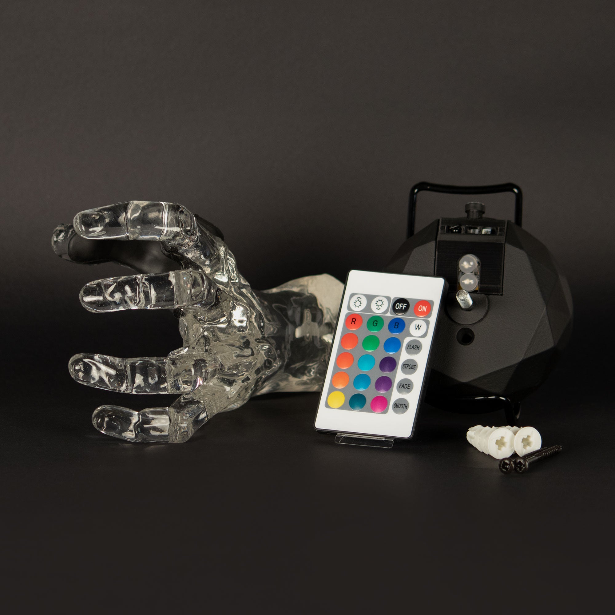 GuitarGrip crystal clear hand guitar mount for displaying your instrument like a work of art. Shows remote and black mounting base.