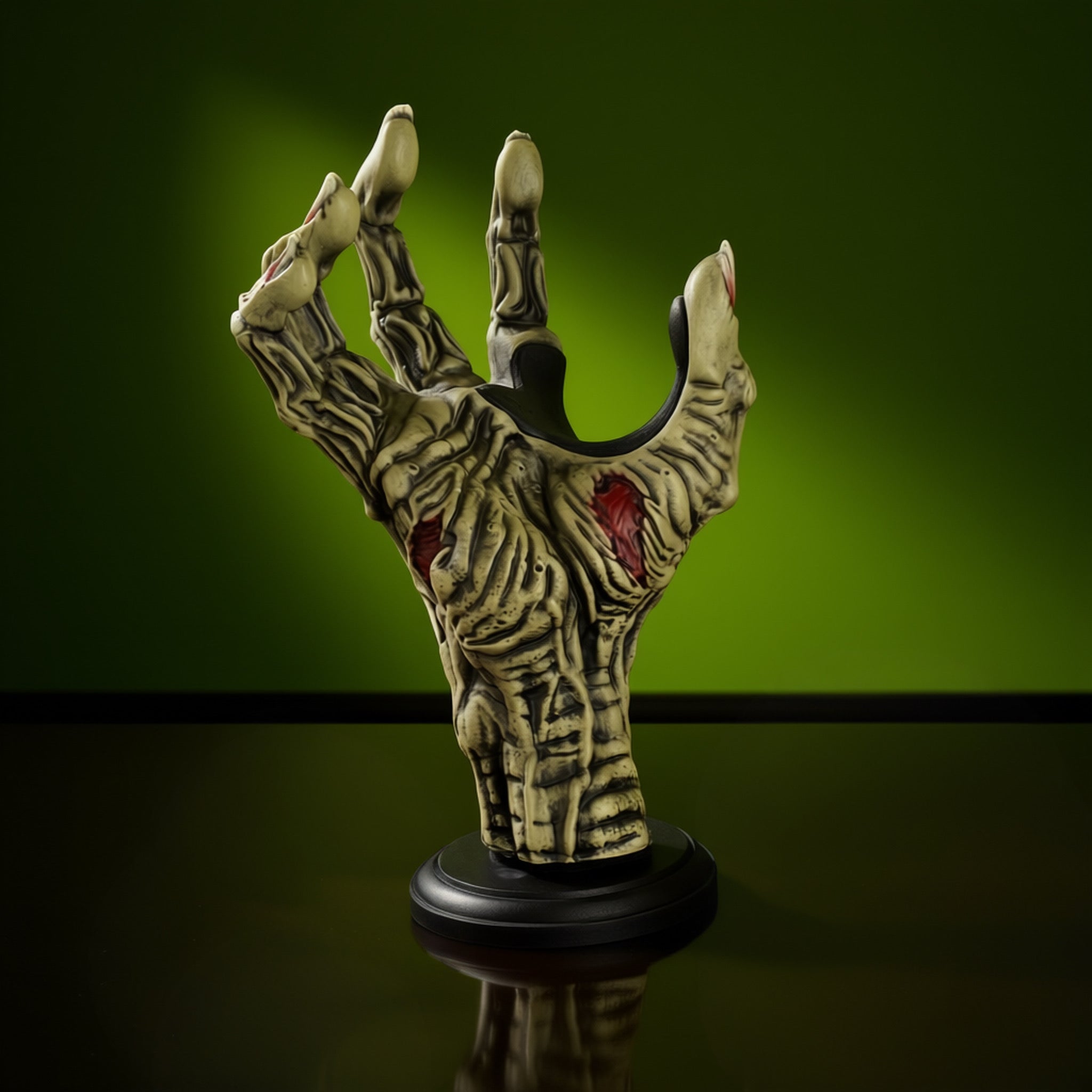 Zombie hand shaped guitar hanger wallmount on green background.