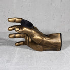 Inside view of gold hand guitar hooks for wall. 