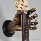 Hand shaped guitar hanger from GuitarGrip holding stratocaster.