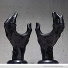 Pair of hand shaped guitar wall holders on grey background.