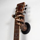 Guitar hanger shaped like a Bronze hand holding a guitar neck against a white background.

