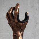 Close-up of the Copper GuitarGrip left-hand guitar hanger showing the cushioned finger pad.