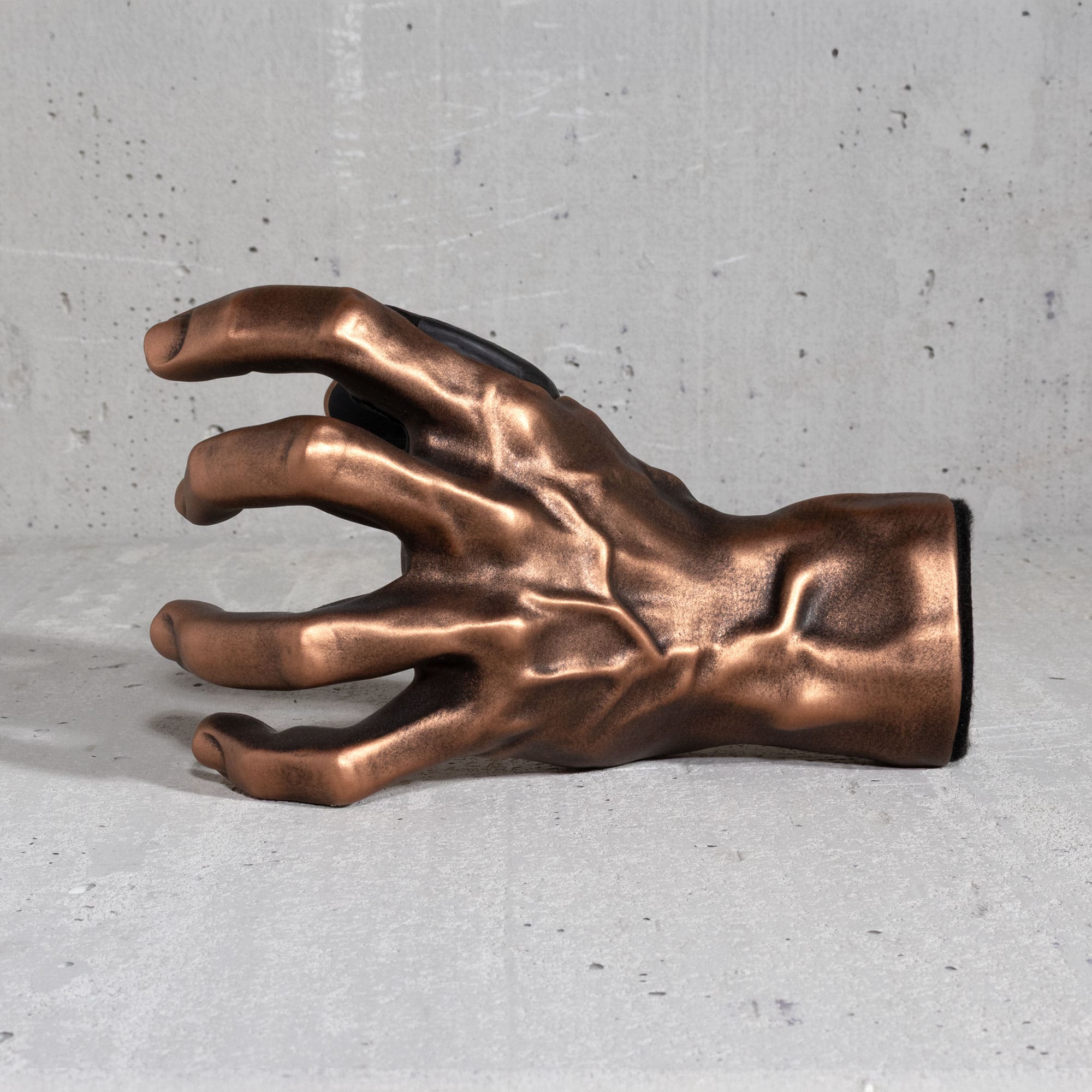Copper GuitarGrip left-hand guitar wall mount displayed from the outer sculpted side.