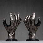 Silver metallic hand guitar hangers matching left and right models.