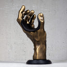 Gold antiqued hand wall hanger for guitar and bass.