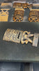 Tiki man ukulele guitar hanger being painted by hand. 